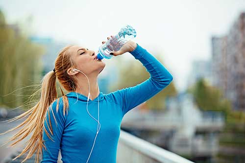 Runner drinking water